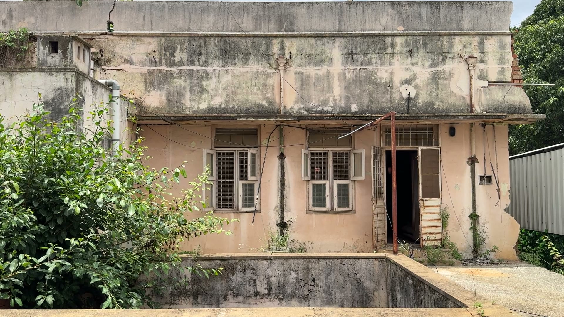 The courtyard-facing rooms of the house, windows and doors beneath a deep eave.