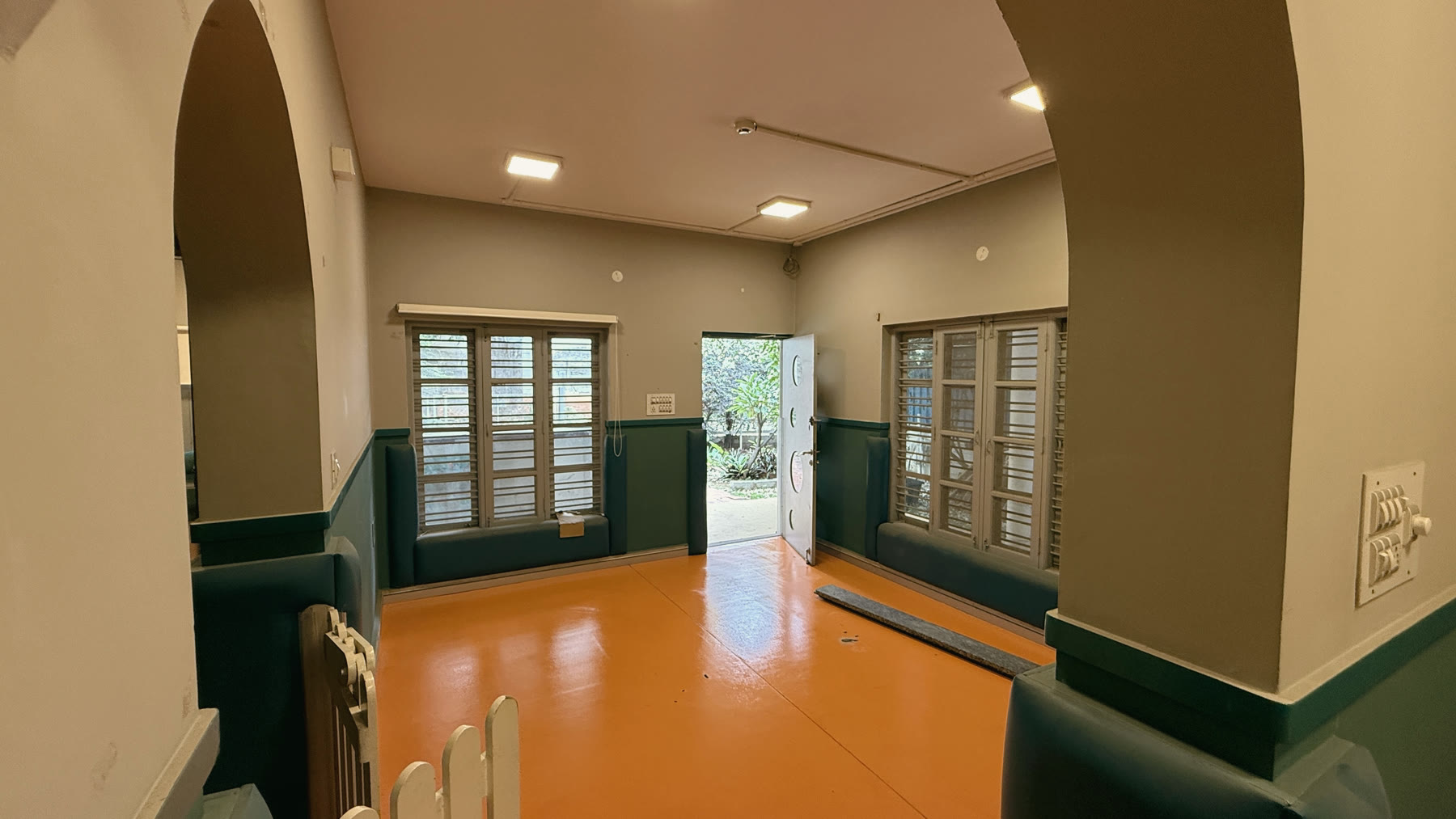 An inner room opening through an arch toward the garden.
